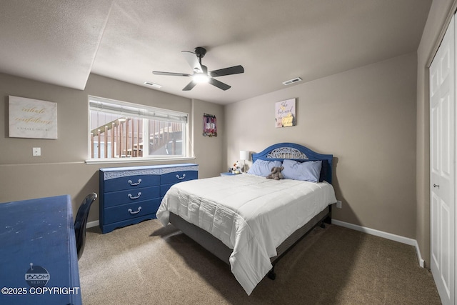 bedroom featuring carpet floors, a textured ceiling, ceiling fan, and a closet