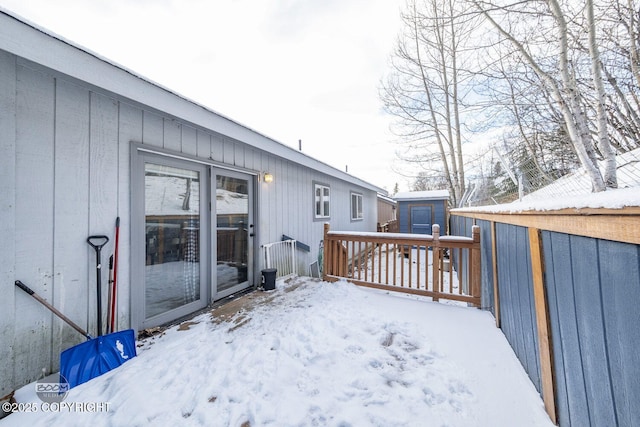 snow covered deck with a storage unit