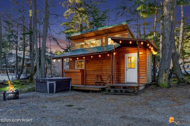 outdoor structure at dusk featuring an outdoor fire pit