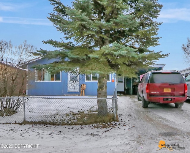 obstructed view of property featuring a fenced front yard