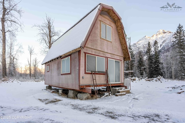 view of snow covered exterior featuring a mountain view