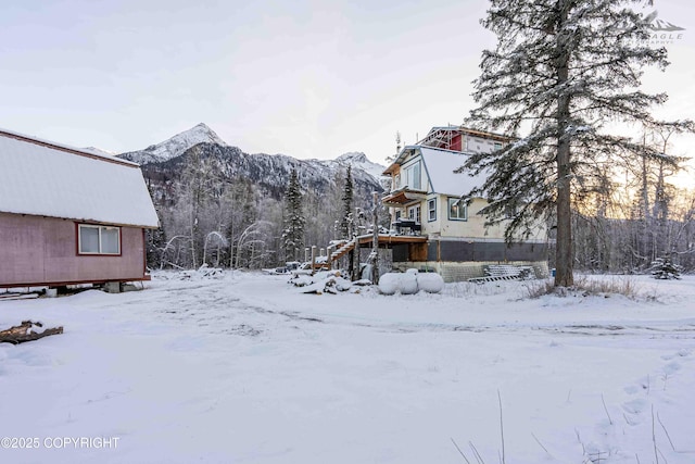 snowy yard with a mountain view