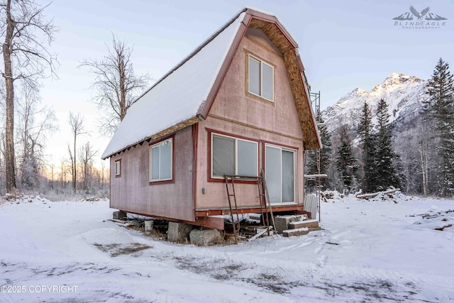 snow covered property featuring a mountain view