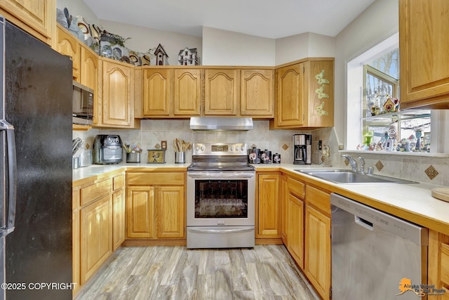 kitchen with sink, stainless steel appliances, and backsplash