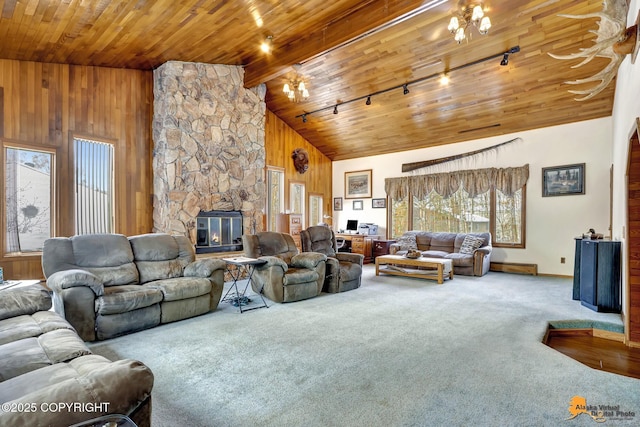 living room featuring rail lighting, carpet flooring, a fireplace, high vaulted ceiling, and wood ceiling