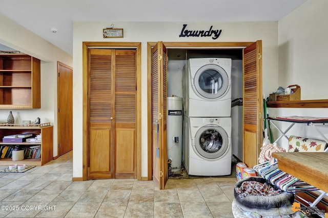 washroom featuring stacked washer / dryer and light tile patterned floors