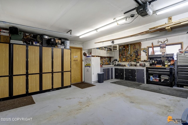 garage featuring a garage door opener, a workshop area, and white refrigerator