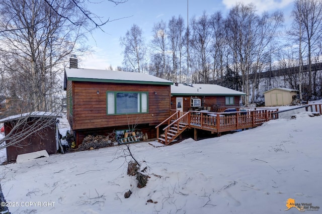 view of front of property with a storage shed and a wooden deck