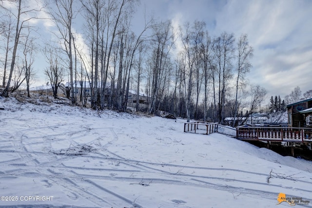 snowy yard with a deck