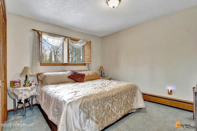 carpeted bedroom with a baseboard heating unit and a textured ceiling