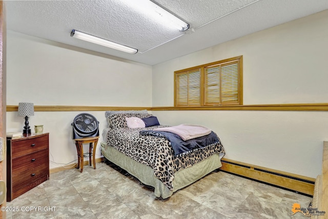 bedroom featuring a textured ceiling and baseboard heating