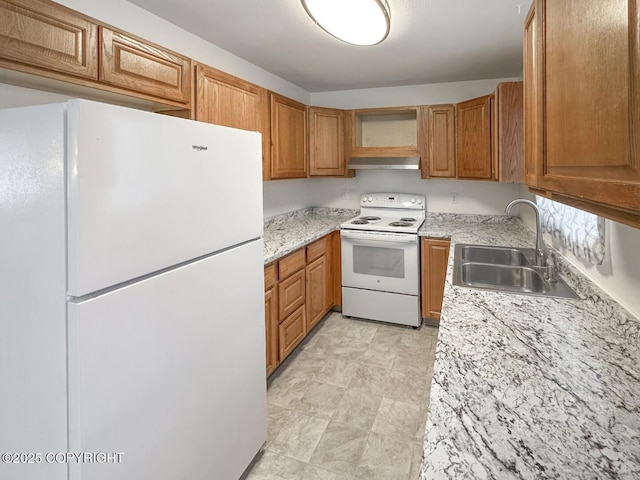 kitchen featuring sink, light stone counters, white appliances, and range hood