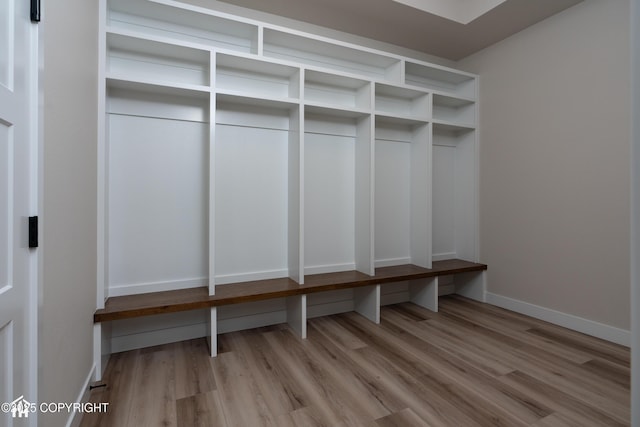 mudroom featuring baseboards and light wood finished floors