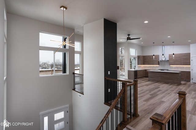 interior space featuring recessed lighting, a ceiling fan, a wealth of natural light, and wood finished floors