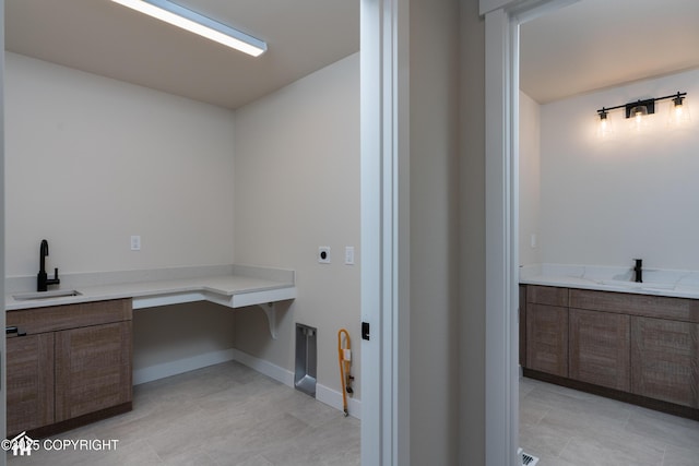 bathroom featuring a sink and baseboards