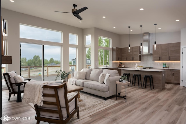 11093 Red Sky Cir, Anchorage, AK 99516 - living area featuring ceiling fan, recessed lighting, light wood-style flooring, and a towering ceiling