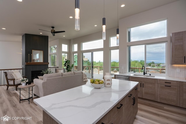 11093 Red Sky Cir, Anchorage, AK 99516 - kitchen featuring recessed lighting, a kitchen island, light wood-style flooring, ceiling fan, and light stone countertops