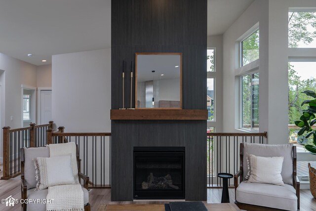 11093 Red Sky Cir, Anchorage, AK 99516 - living room with light wood-type flooring, a towering ceiling, and a fireplace
