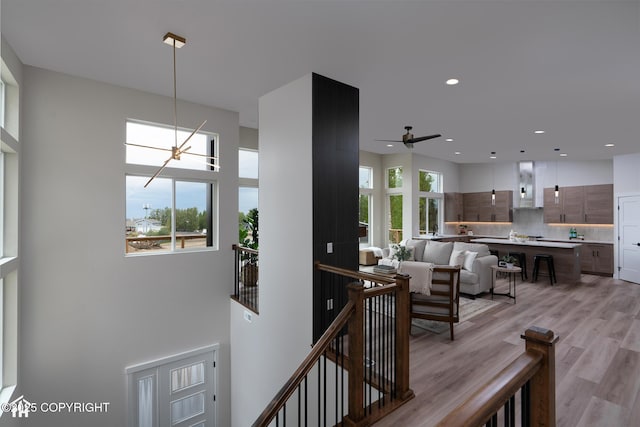 11093 Red Sky Cir, Anchorage, AK 99516 - hallway featuring an upstairs landing, light wood finished floors, recessed lighting, and a high ceiling