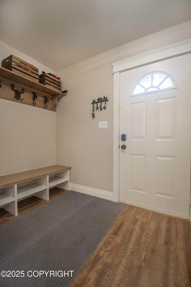 mudroom with wood finished floors and baseboards