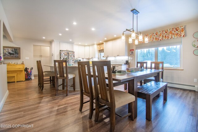 dining room with a baseboard radiator, dark wood-style flooring, and recessed lighting