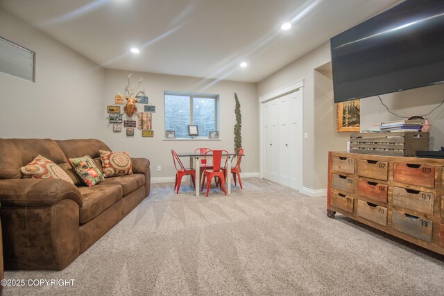 living area with baseboards, recessed lighting, and light colored carpet