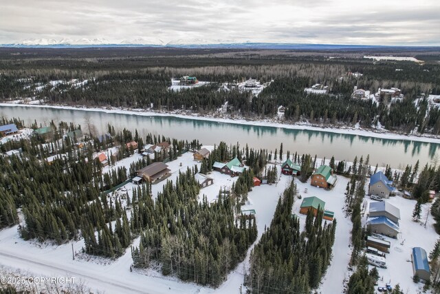 snowy aerial view featuring a water view