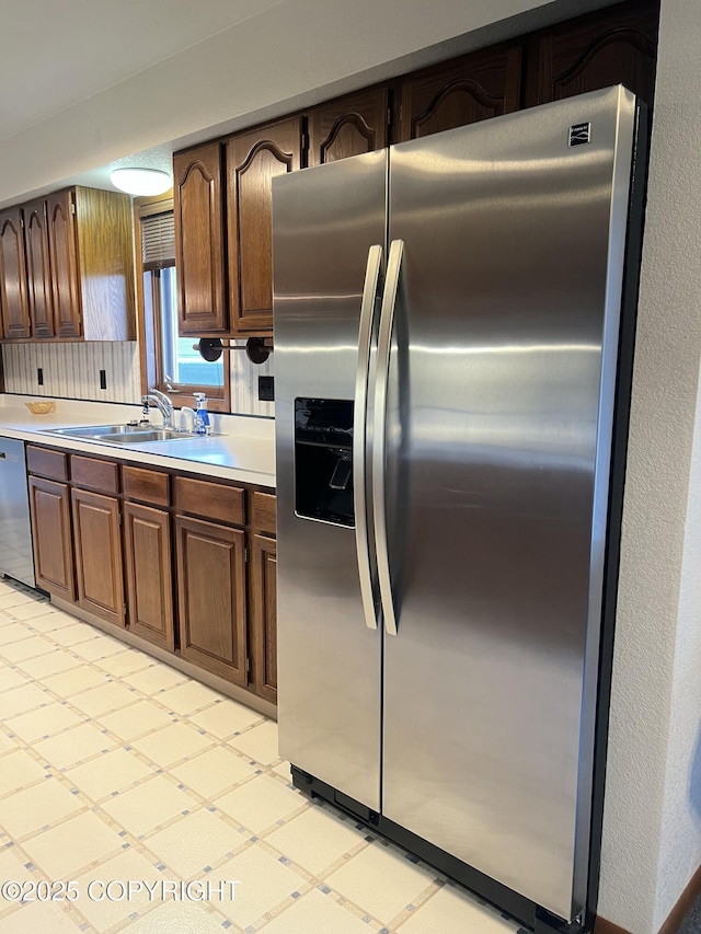 2707 W 31st Ave, Anchorage, AK 99517 - kitchen with stainless steel appliances, a sink, light countertops, and light floors