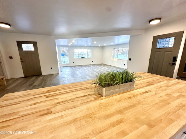 foyer featuring wood finished floors and baseboards