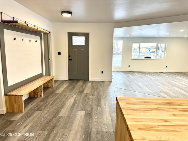 mudroom featuring recessed lighting, wood finished floors, and baseboards