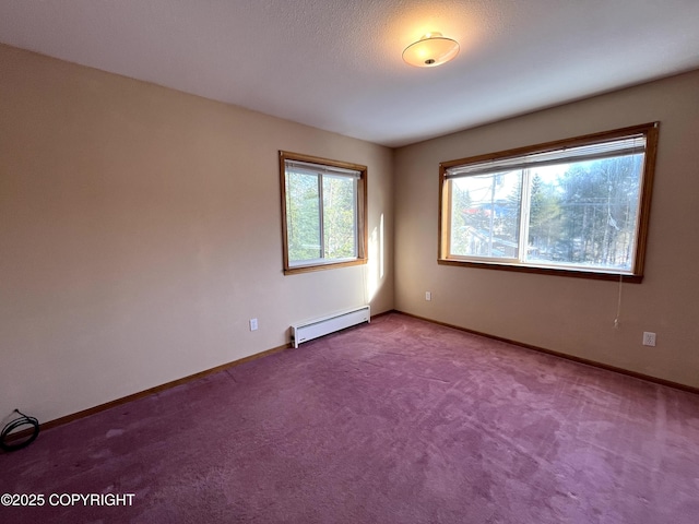 carpeted spare room with a baseboard radiator and a healthy amount of sunlight