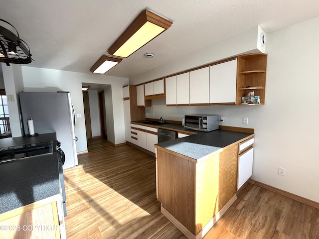 kitchen featuring white cabinetry, appliances with stainless steel finishes, sink, and light hardwood / wood-style flooring