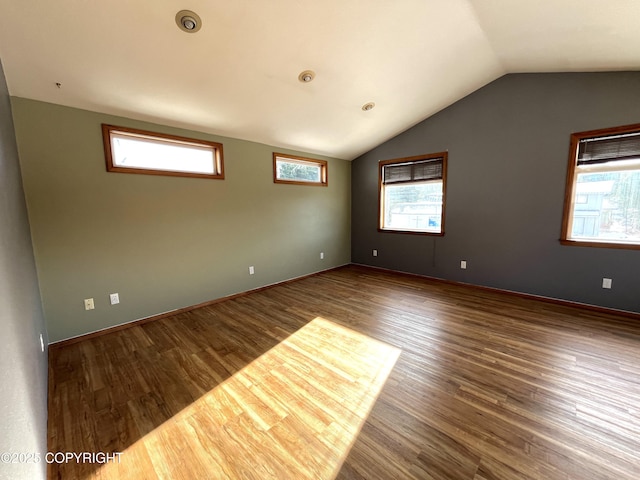 empty room featuring hardwood / wood-style floors and vaulted ceiling