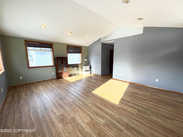 unfurnished living room with lofted ceiling and hardwood / wood-style floors