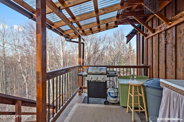 deck featuring grilling area and outdoor dry bar