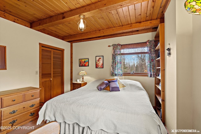 bedroom featuring a closet, wooden ceiling, and beamed ceiling