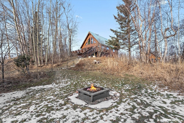 snowy yard featuring an outdoor fire pit