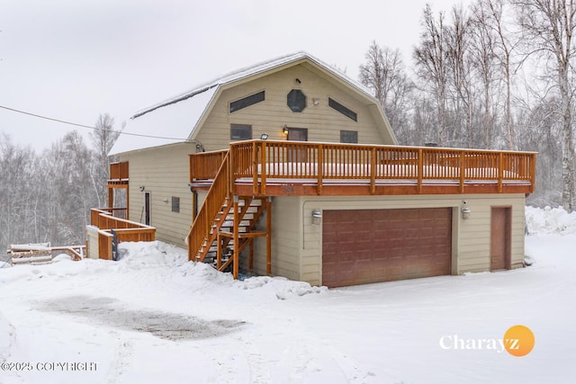 view of front of home with stairway, a garage, a deck, and a gambrel roof