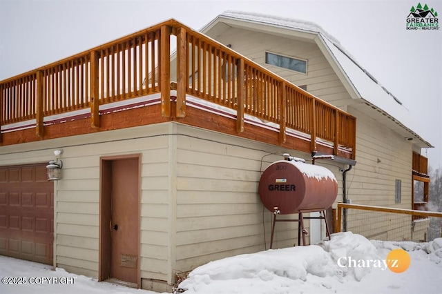 snow covered property with a balcony