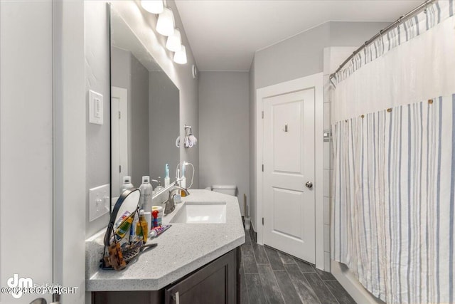 bathroom featuring vanity, toilet, and a shower with shower curtain