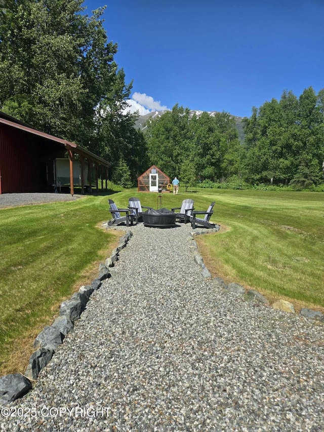 exterior space featuring an outbuilding and a fire pit