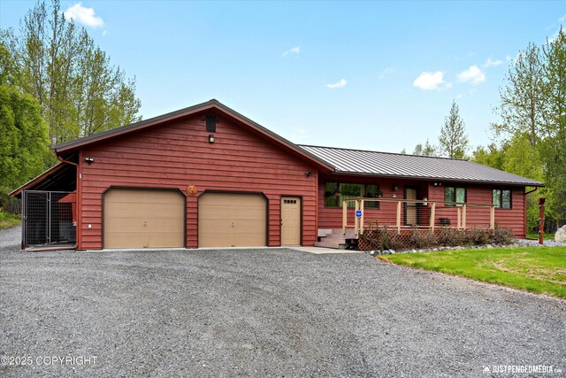 5853 E Edgerton Parks Rd, Palmer, AK 99645 - rustic home featuring a garage, a standing seam roof, a metal roof, gravel driveway, and covered porch