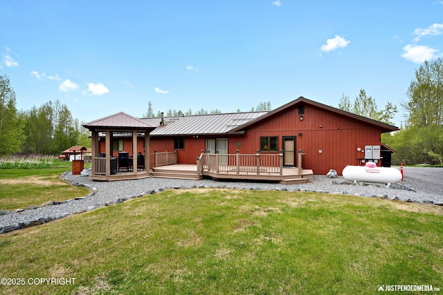 5853 E Edgerton Parks Rd, Palmer, AK 99645 - back of property with a lawn, a wooden deck, a metal roof, a gazebo, and a standing seam roof