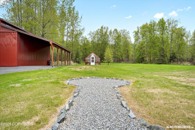 5853 E Edgerton Parks Rd, Palmer, AK 99645 - view of green lawn with an outbuilding