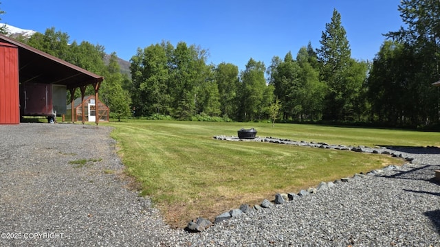 5853 E Edgerton Parks Rd, Palmer, AK 99645 - view of grassy yard featuring a shed