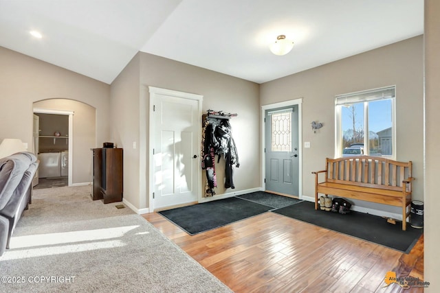 foyer entrance with lofted ceiling and dark hardwood / wood-style floors