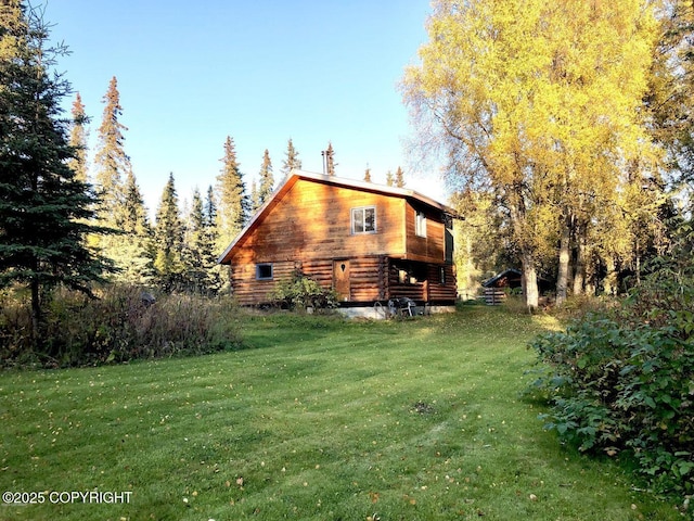 rear view of house with a lawn