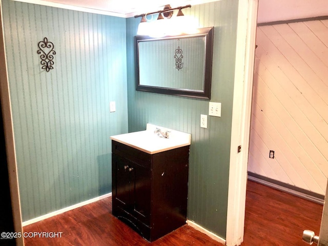 bathroom with vanity, hardwood / wood-style floors, and wooden walls