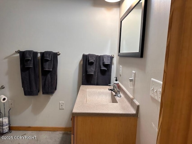 bathroom featuring baseboards and vanity