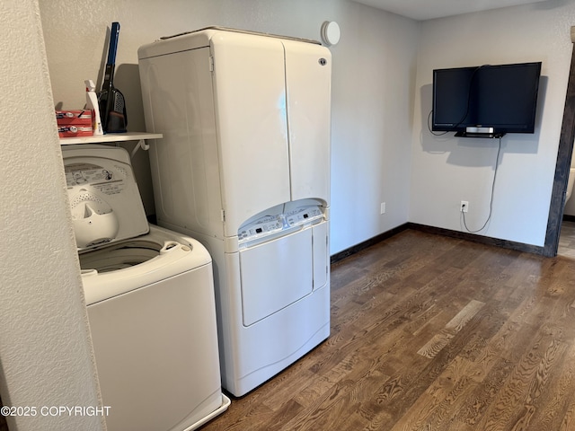 clothes washing area featuring dark hardwood / wood-style floors and washing machine and dryer